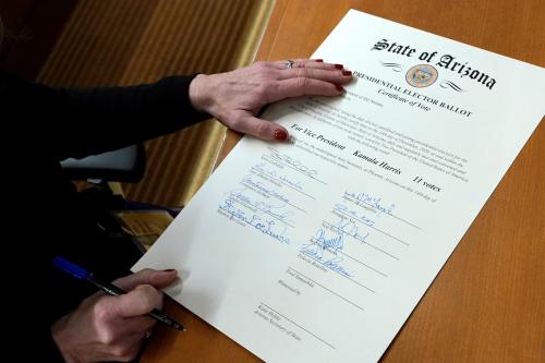 Felecia Rotellini, a member of Arizona's Electoral College, signs the Arizona Presidential Elector Ballot certificate in Phoenix, Arizona, U.S. December 14, 2020.