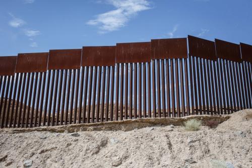 A view from below of a section of the U.S.-Mexico border wall